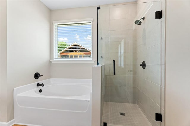 bathroom featuring a bath and a stall shower