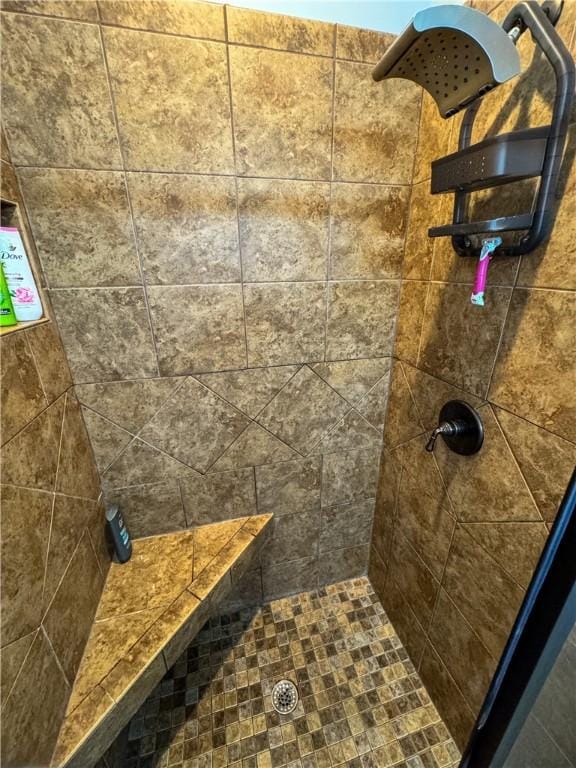 bathroom with tiled shower