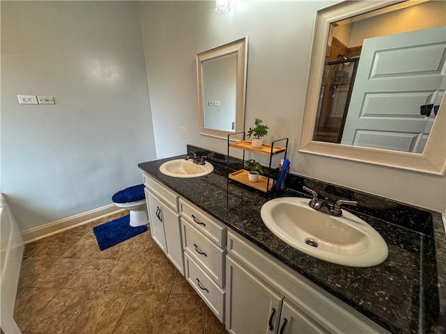 bathroom with a shower with door, vanity, and toilet