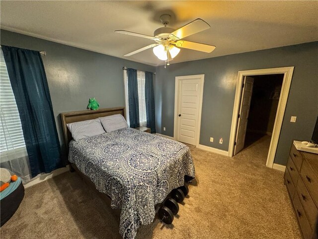 bedroom featuring a closet, ceiling fan, and carpet