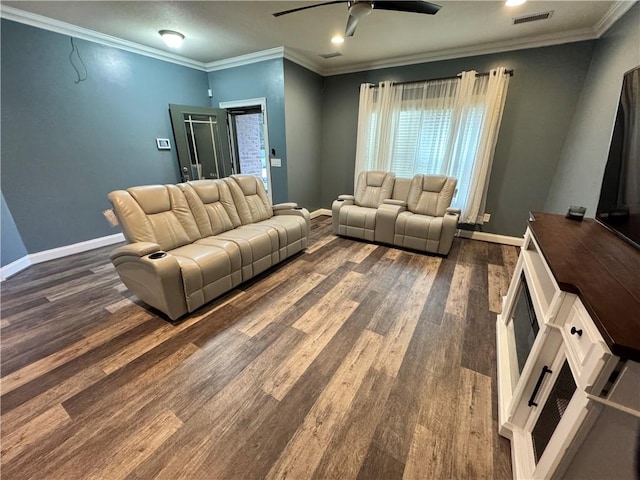 living room with dark wood-type flooring, ornamental molding, and ceiling fan