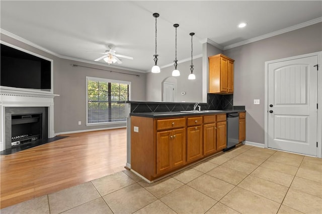 kitchen with kitchen peninsula, tasteful backsplash, stainless steel dishwasher, ornamental molding, and light tile patterned flooring