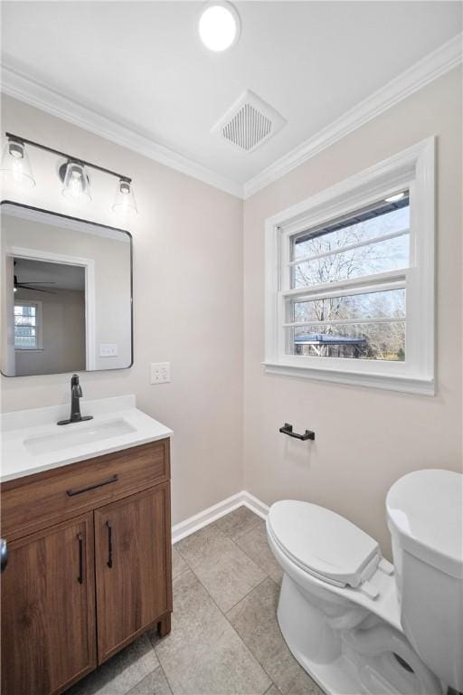 bathroom featuring crown molding, visible vents, toilet, vanity, and baseboards