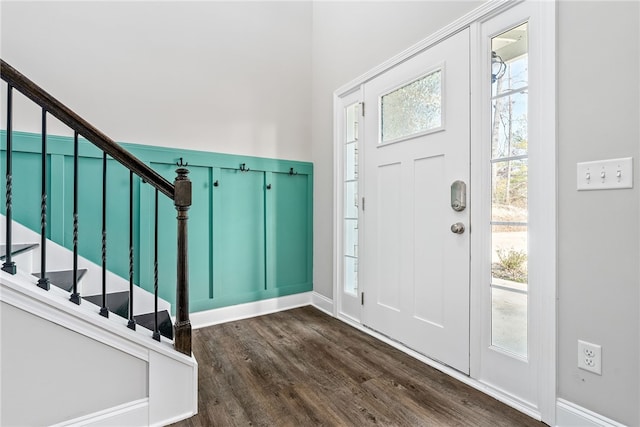 foyer entrance with dark wood-type flooring and stairway