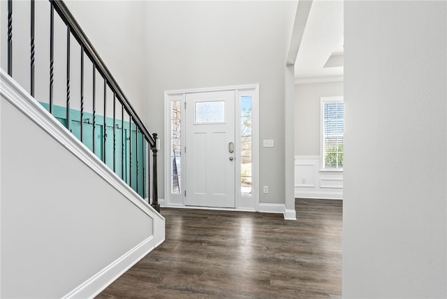 entryway featuring stairs, wainscoting, wood finished floors, and baseboards