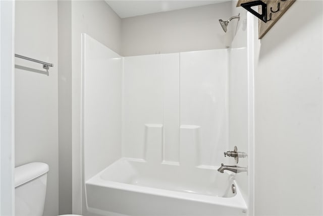 bathroom featuring toilet and bathing tub / shower combination