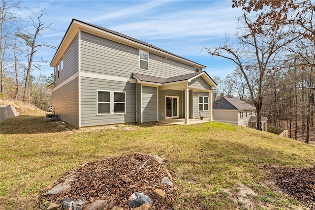 view of front of house featuring a front yard and a patio