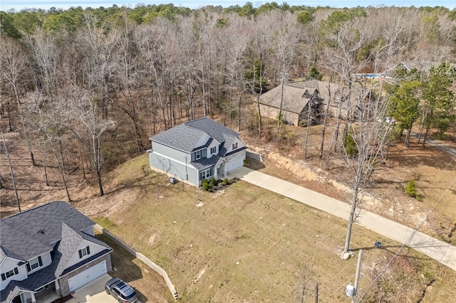 birds eye view of property with a forest view