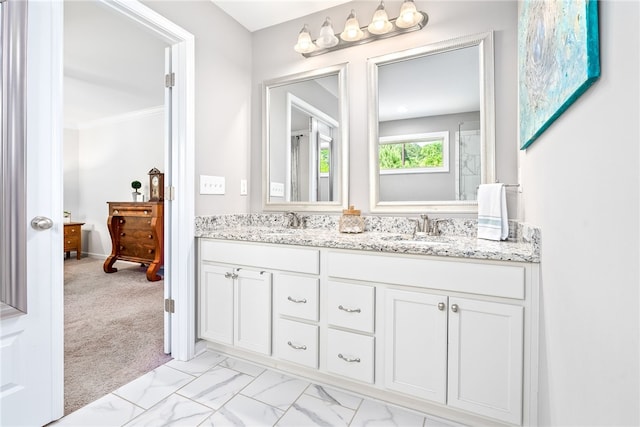 full bath featuring crown molding, double vanity, a sink, and marble finish floor