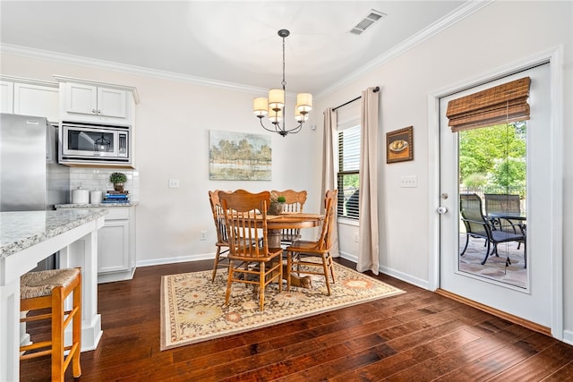 dining area featuring visible vents, baseboards, a notable chandelier, ornamental molding, and dark wood-type flooring