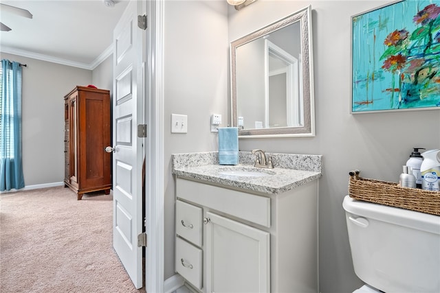 bathroom with vanity, crown molding, toilet, and ceiling fan