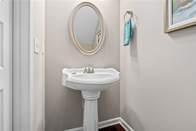 bathroom featuring baseboards and wood finished floors