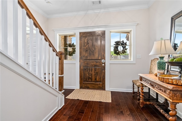 foyer featuring visible vents, ornamental molding, stairs, baseboards, and hardwood / wood-style flooring
