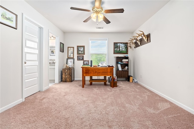carpeted office with baseboards, a ceiling fan, and visible vents