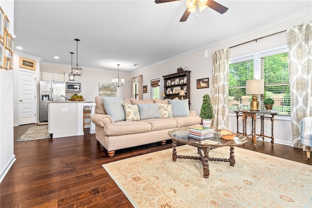 living area with crown molding, ceiling fan with notable chandelier, and dark wood-style floors