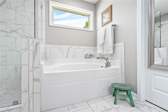 bathroom with a garden tub, a stall shower, and marble finish floor