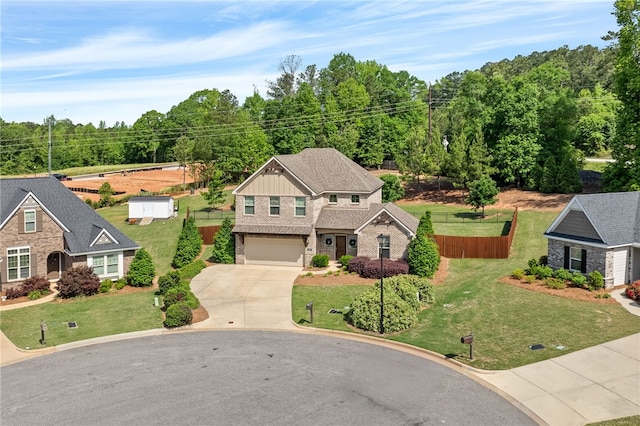 view of front of house with a garage, fence, concrete driveway, and a front yard