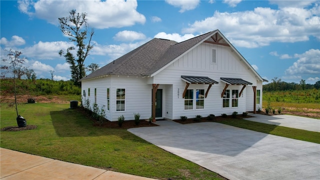 033 Crossing Ct W, Valley, AL 36854 - modern farmhouse style home with board and batten siding, a front lawn, roof with shingles, and central AC