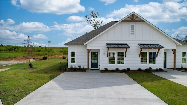 033 Crossing Ct W, Valley, AL 36854 - modern inspired farmhouse featuring board and batten siding, a shingled roof, a front lawn, and a standing seam roof