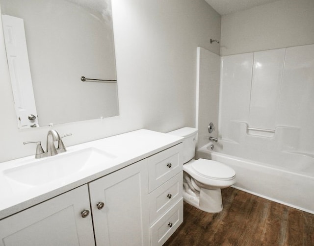 full bathroom featuring hardwood / wood-style flooring, vanity, toilet, and shower / tub combination