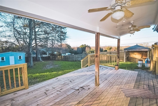 wooden deck featuring a yard and a storage unit