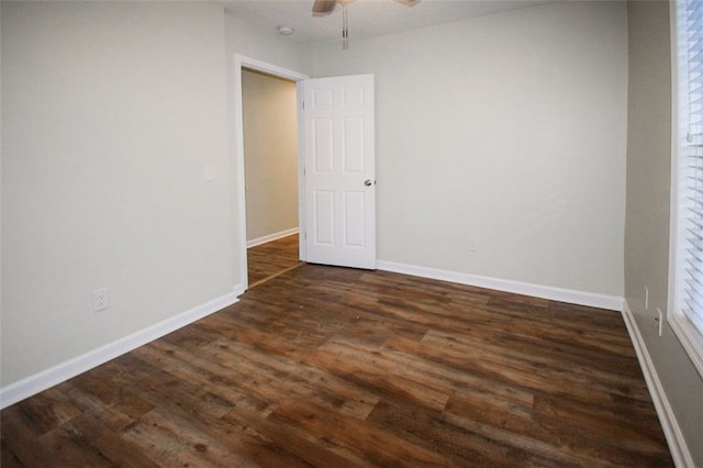 unfurnished room with ceiling fan and dark hardwood / wood-style flooring