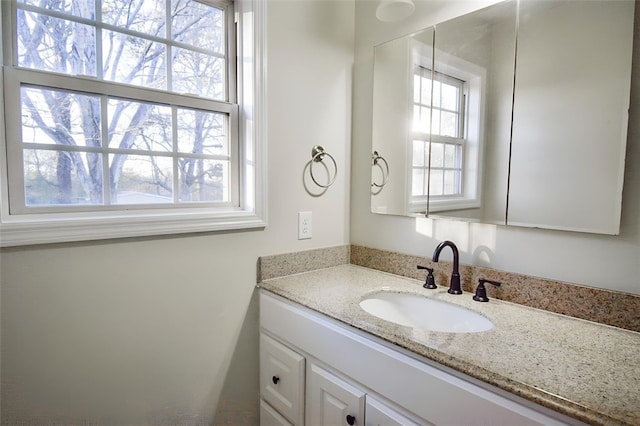 bathroom featuring plenty of natural light and vanity