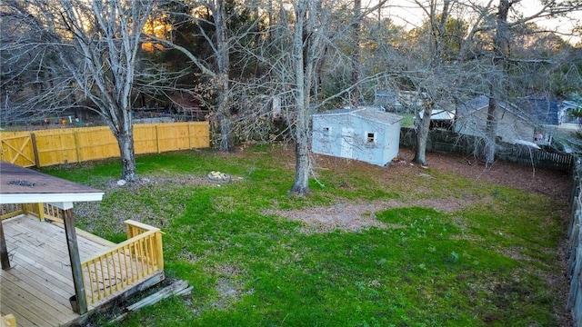 view of yard featuring a storage unit and a wooden deck