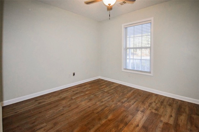 spare room featuring ceiling fan and dark hardwood / wood-style flooring