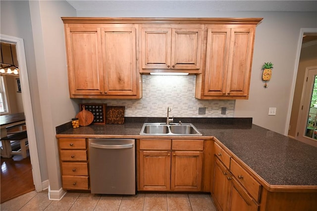 321 Saint James Dr, Auburn, AL 36830 - kitchen with dark countertops, dishwasher, light tile patterned floors, a sink, and backsplash