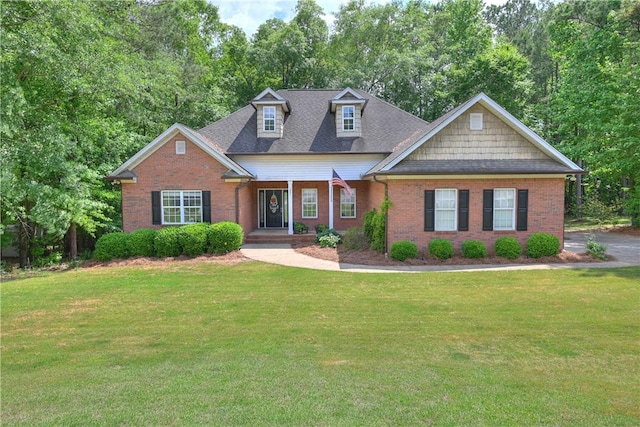 321 Saint James Dr, Auburn, AL 36830 - view of front facade featuring covered porch, a front yard, and brick siding