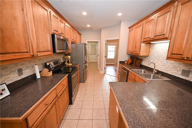321 Saint James Dr, Auburn, AL 36830 - kitchen with a sink, dark countertops, light tile patterned floors, and stainless steel appliances
