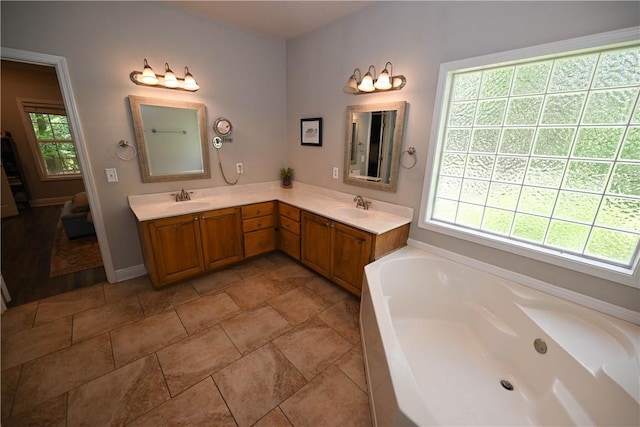 321 Saint James Dr, Auburn, AL 36830 - bathroom featuring double vanity, a sink, and a bath