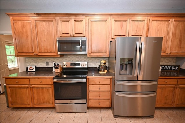 321 Saint James Dr, Auburn, AL 36830 - kitchen with dark countertops, appliances with stainless steel finishes, and light tile patterned floors