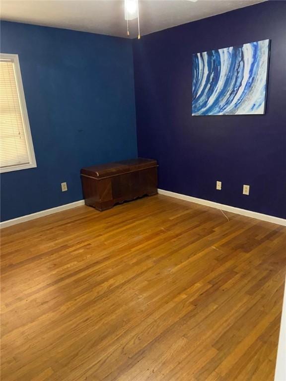 spare room with wood-type flooring