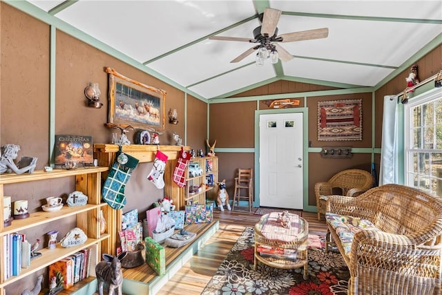 living area featuring vaulted ceiling and ceiling fan