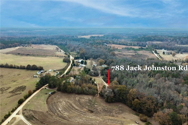 birds eye view of property with a rural view