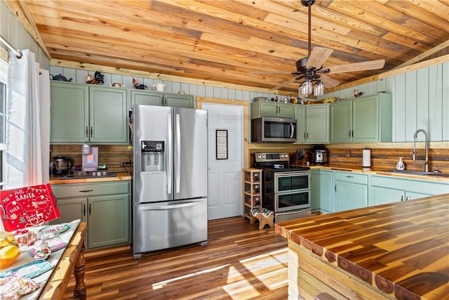 kitchen featuring appliances with stainless steel finishes, ceiling fan, green cabinets, and sink