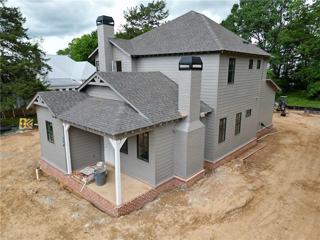 410 Geneva St, Opelika, AL 36801 - back of property with a chimney, a shingled roof, and a patio
