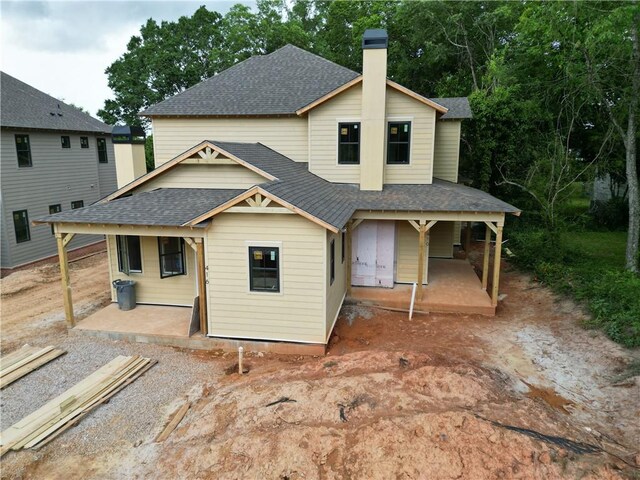 410 Geneva St, Opelika, AL 36801 - back of property with a shingled roof, covered porch, and a chimney
