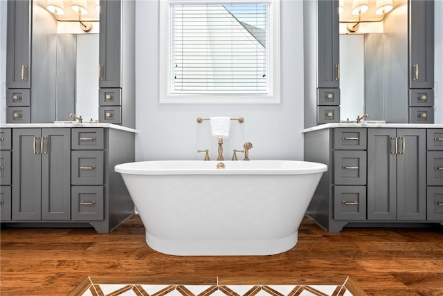 2051 Moores Mill Rd Unit K, Auburn, AL 36830 - full bath featuring wood finished floors, two vanities, and a freestanding bath