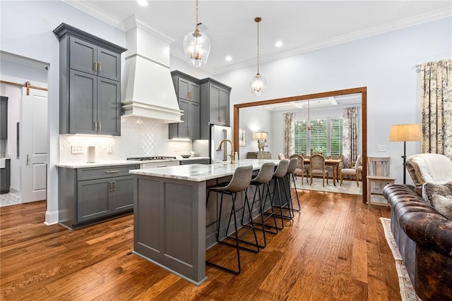 2051 Moores Mill Rd Unit K, Auburn, AL 36830 - kitchen featuring gray cabinetry, a kitchen breakfast bar, dark wood-style flooring, crown molding, and open floor plan