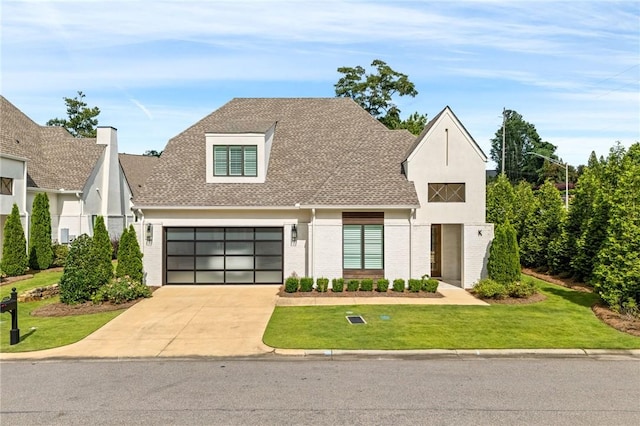 2051 Moores Mill Rd Unit K, Auburn, AL 36830 - view of front of house featuring concrete driveway, a front lawn, brick siding, and roof with shingles