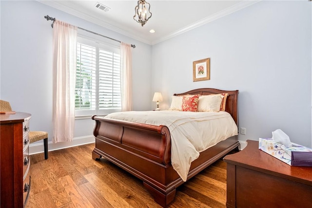 2051 Moores Mill Rd Unit K, Auburn, AL 36830 - bedroom with crown molding, wood finished floors, and a chandelier