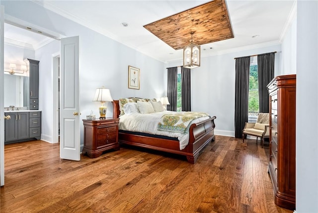 2051 Moores Mill Rd Unit K, Auburn, AL 36830 - bedroom featuring dark wood finished floors, a chandelier, and ornamental molding