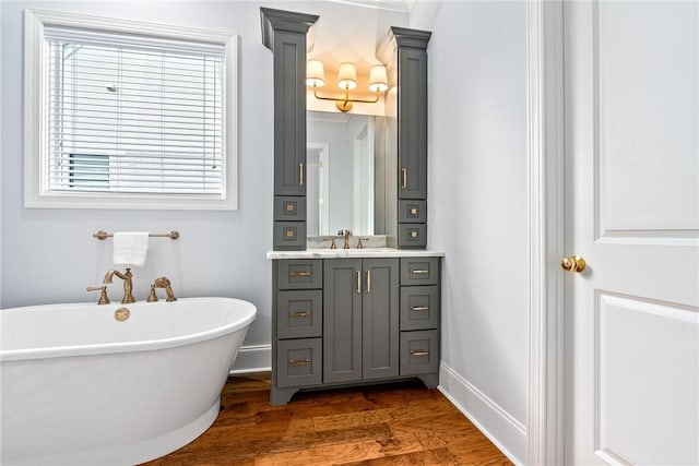 2051 Moores Mill Rd Unit K, Auburn, AL 36830 - bathroom featuring a soaking tub, wood finished floors, and vanity