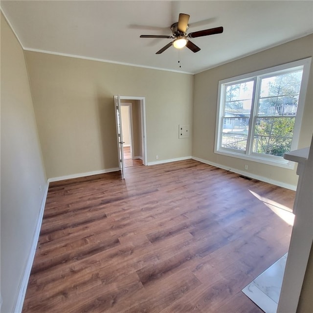 spare room featuring ceiling fan, ornamental molding, and hardwood / wood-style flooring