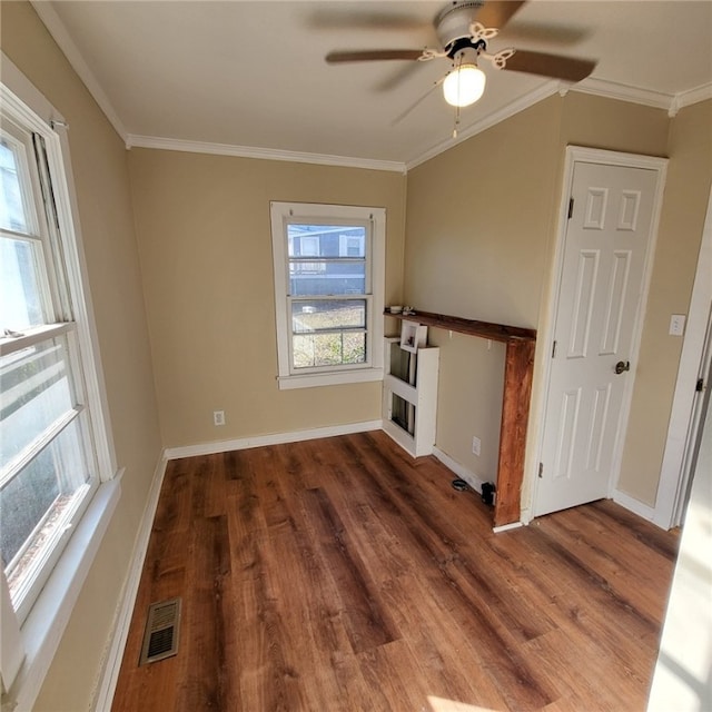 empty room featuring crown molding, ceiling fan, and dark hardwood / wood-style floors