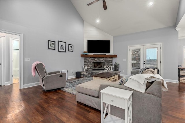 living room featuring ceiling fan, a fireplace, dark hardwood / wood-style floors, high vaulted ceiling, and french doors