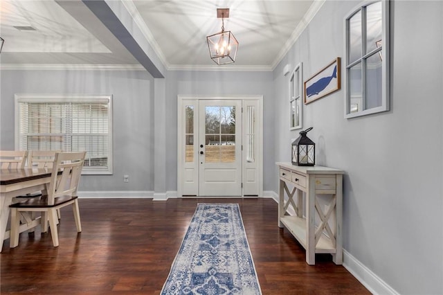 foyer entrance featuring dark hardwood / wood-style flooring, crown molding, and a notable chandelier